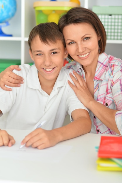 Mère émotionnelle avec son fils à faire ses devoirs