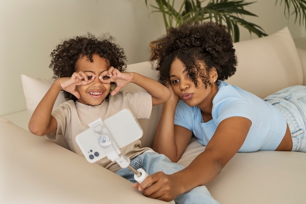 Mère et enfant prenant selfie vue de face