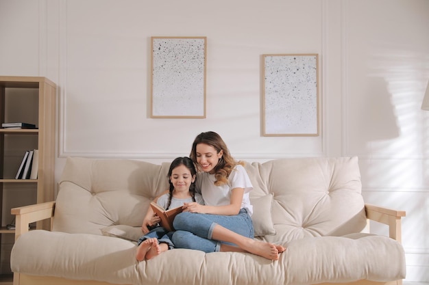 Mère, fille, livre lecture, sur, sofa, chez soi