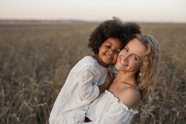 mère et fille marchant dans un champ d'automne