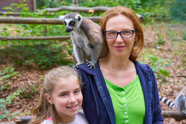 mère et fille s&#39;amuser avec un lémurien à queue d&#39;anneau