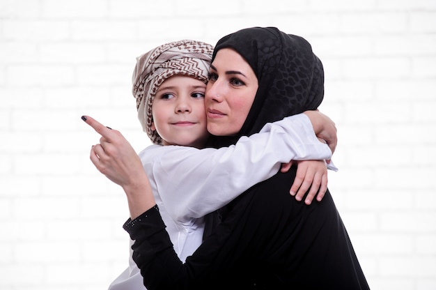 Mère et fils arabe posant à l'intérieur.