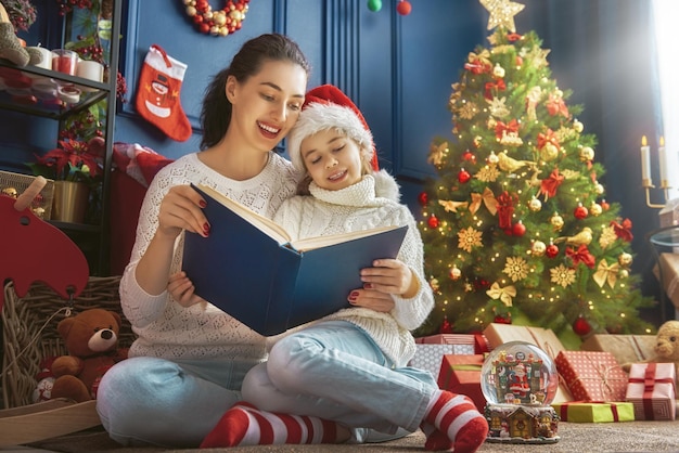 Mère lisant un livre à Noël