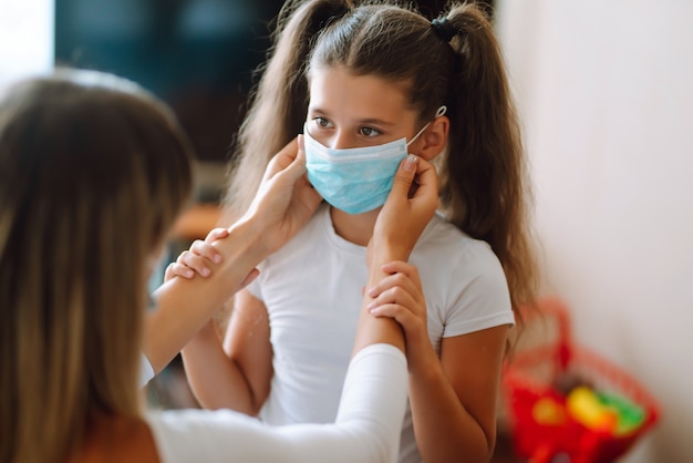 La mère met son masque médical stérile de fille