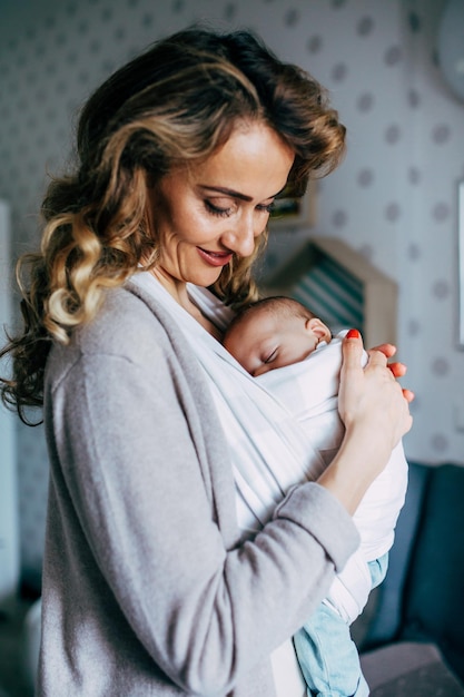 Une mère qui porte son fils nouveau-né à la maison