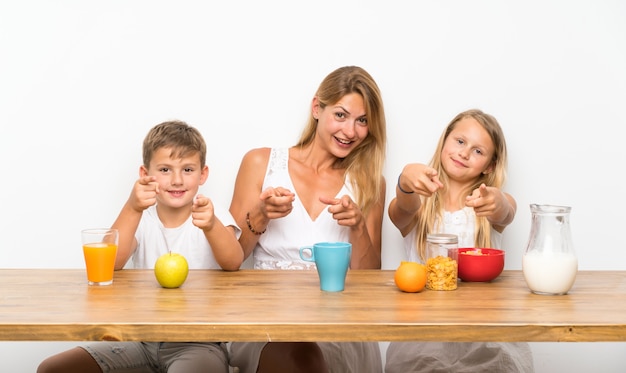 Mère avec ses deux enfants prenant son petit déjeuner