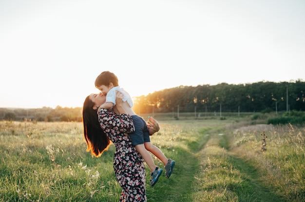 Mère Stilish et beau fils s'amusant sur la nature.