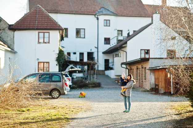 Mère tenir sa fille sur les mains dans l'arrière-cour