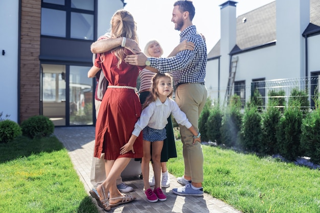 Mes parents. Femme blonde détendue gardant le sourire sur son visage tout en embrassant son fils