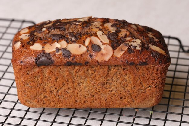 Une miche de pain aux bananes avec des pépites de chocolat sur une grille.