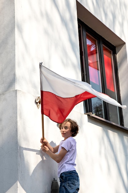 Le mignon garçon tenant le drapeau de la Pologne Jour du drapeau polonais Jour de l'indépendance