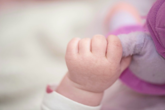 mignon petit bébé jouant avec la main et souriant sans dents sourire drôle