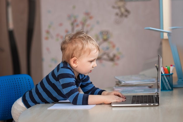 Mignon petit garçon ayant cours vidéo ou chat vidéo avec les grands-parents. Concept de communication à distance d'isolement de quarantaine