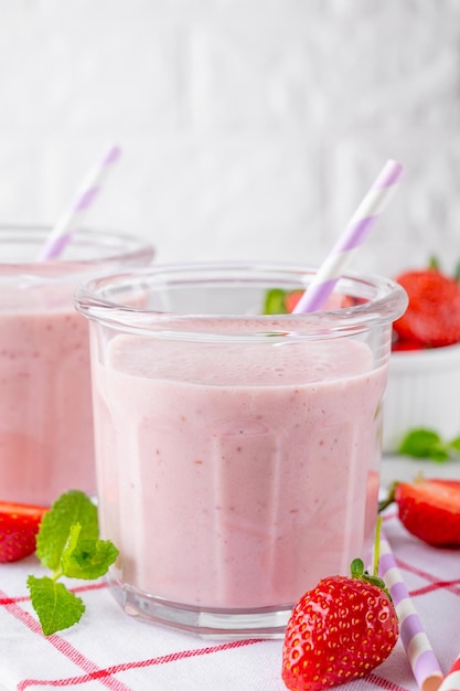 Milk-shake aux fraises ou cocktail de smoothie dans le bocal en verre sur un fond de béton gris Espace de copie