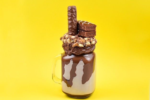 Milk-shake extrême au chocolat avec gâteau au brownie pâte au chocolat et bonbons Crazy freakshake food trend Copy space