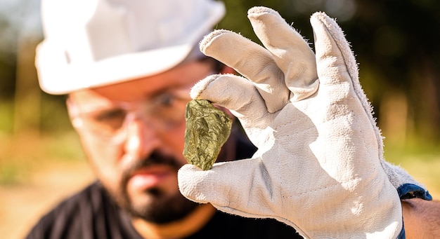 Miner holding gold nugget point focus on the gemstone Mineral exploration concept Minnesota United States