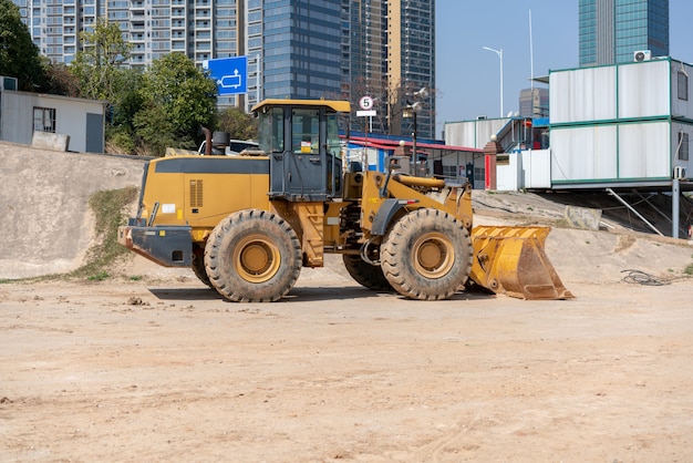 Mini bulldozer de chantier de construction de bâtiment industriel nivelant et remuant le sol pendant la construction d&#39;une autoroute