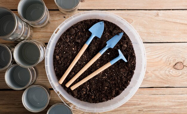 mini jardin avec des canettes en aluminium recyclées sur une table en bois rustique