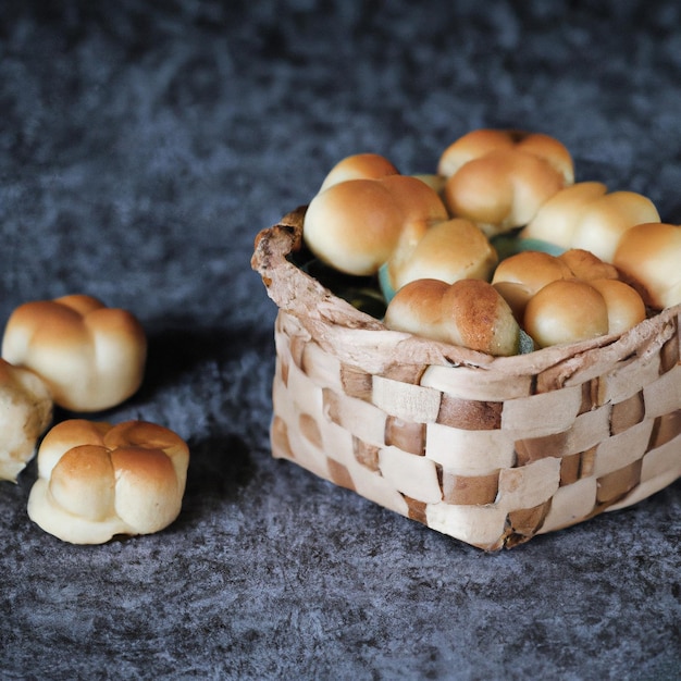 Des mini-pâtisseries qui venaient d'être prêtes dans un panier de paille sur la table en ciment brûlé