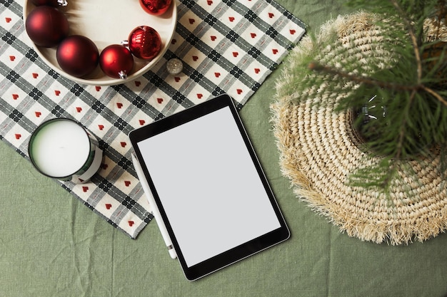 Mise en page de Noël sur la table avec tablette de décorations avec écran vierge pour votre maquette publicitaire