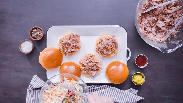 Mise à plat. Pas à pas. Faire des sandwichs au porc effiloché avec salade de chou sur des petits pains briochés.