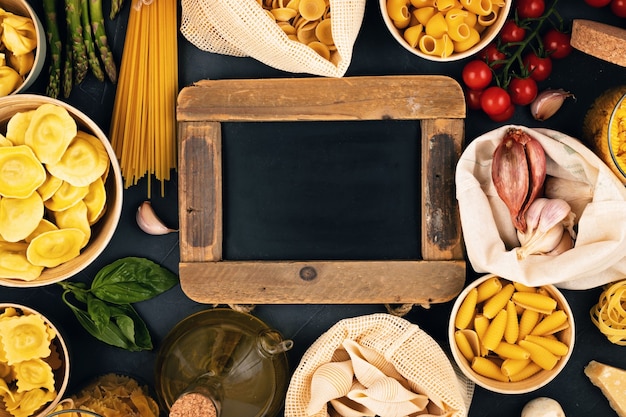 Mise à plat avec des pâtes italiennes biologiques traditionnelles et des ingrédients de cuisine dans des sacs en coton réutilisables et des récipients en verre. Zéro déchet, concept sans plastique