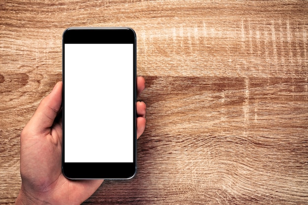Photo mockup écran blanc téléphone portable sur la vieille table en bois