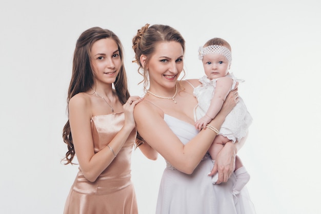 Mode de mariage pour les femmes de tous les âges. Un groupe de femmes en robes de soirée longues sur un blanc