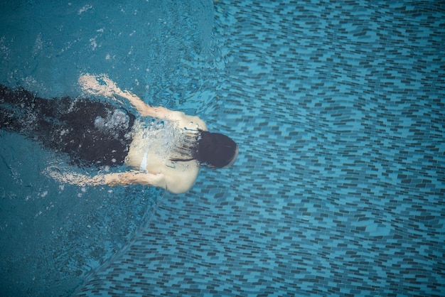 Mode de vie d'une femme asiatique avec de l'eau d'été, jeune fille portant des articles de natation pour nager dans une piscine d'eau, temps de vacances en vacances pour se détendre et se réjouir d'un plaisir sain