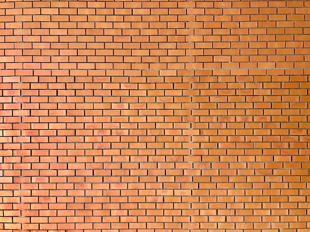 Modèle de brique orange sur le mur