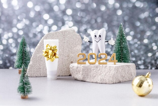 Photo modèle de dessin animé d'une dent les numéros 2024 sur un podium fait de dentifrice en pierre et d'arbres de noël