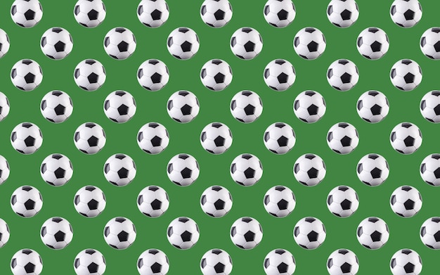 Modèle sans couture de boules. Ballons de football noirs et blancs volant dans les airs, isolés sur fond vert. Concept minimaliste du sport