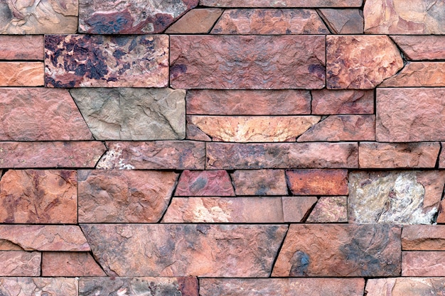 Photo modèle sans couture de carreaux de granit décoratifs. modèle de mur en pierre pour la décoration extérieure et intérieure. pierre de granit rouge