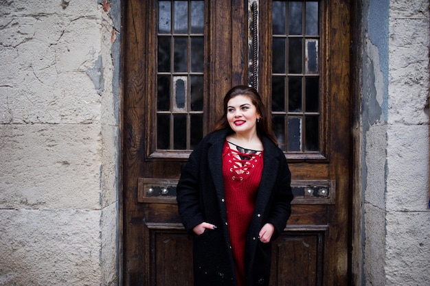 Modèle de taille plus brune au rouge dans la rue de la ville.