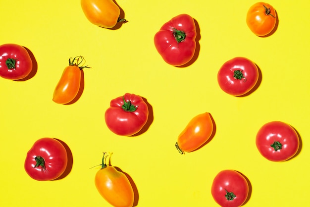 Modèle de tomates jaunes et rouges sur fond jaune