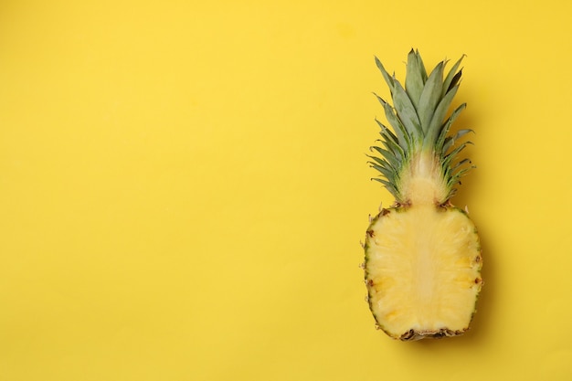 La moitié d'un ananas mûr savoureux sur fond jaune