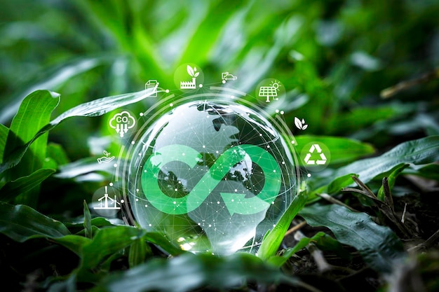 Le monde de cristal sur l'herbe verte avec le symbole de l'infini et l'écologie de l'environnement incluent la réutilisation, la réduction, le recyclage, la réduction du carbone et la consommation alternative d'énergie pour l'économie circulaire et le concept durable