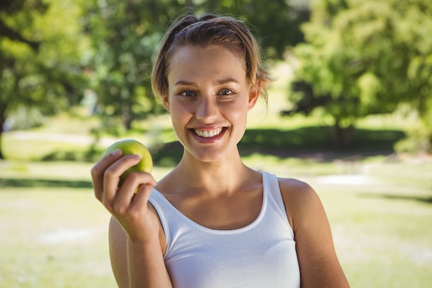 Monter la femme tenant une pomme verte