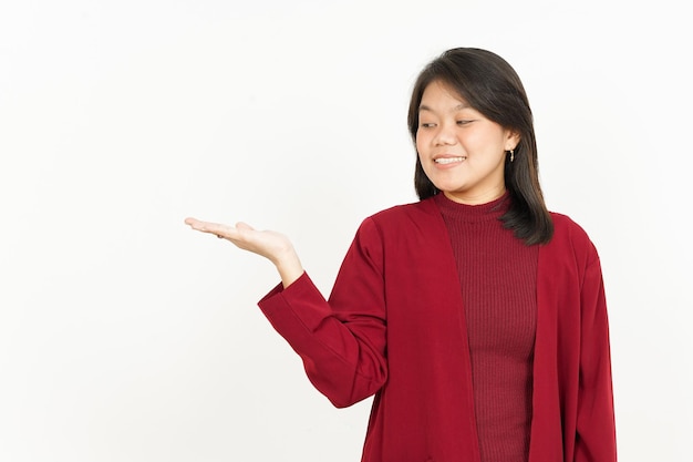 Montrant le produit recommandé sur la paume ouverte de la belle femme asiatique portant une chemise rouge