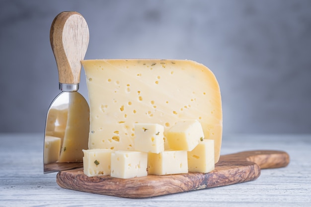 Morceau de fromage à la bière ammergauer sur une table en bois clair.