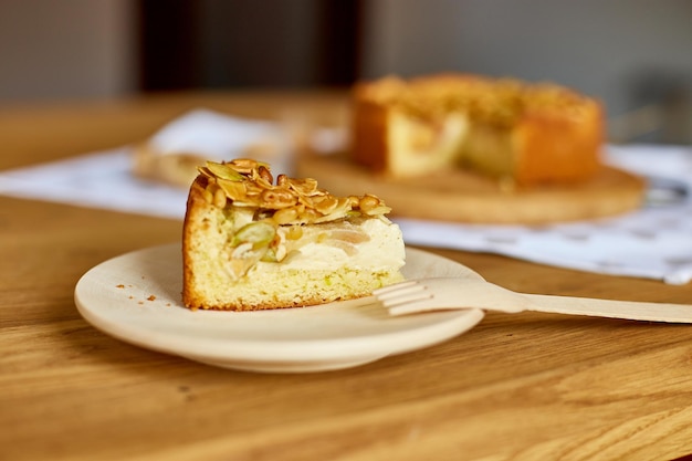 Morceau de tarte aux pommes ou aux poires avec des noix de caramel sur la vue de dessus de l'espace de copie de table en bois