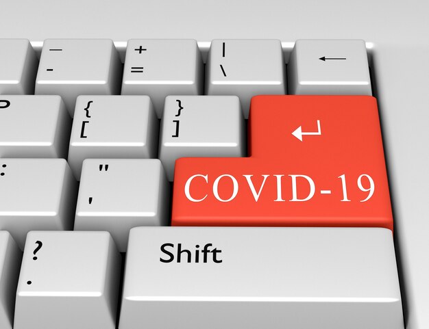 Le mot COVID-19 est écrit sur la touche Entrée du clavier de l'ordinateur