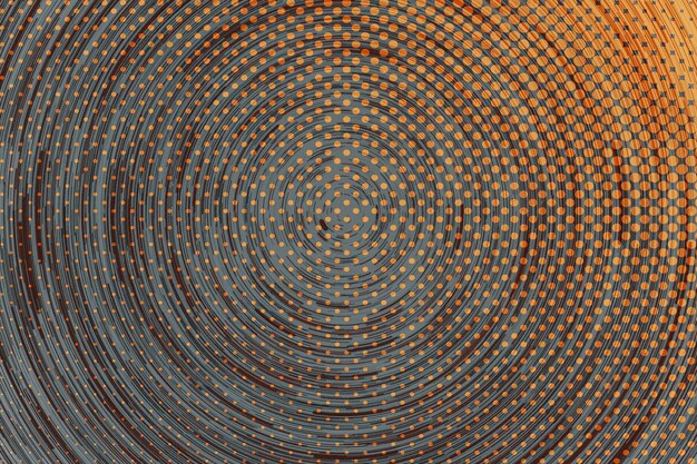 Un motif abstrait noir et orange avec une spirale de points.