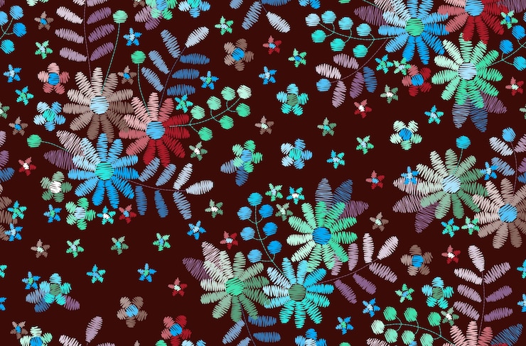 Photo motif de broderie coloré dessin sans couture avec des fleurs et des feuilles brillantes sur fond noir