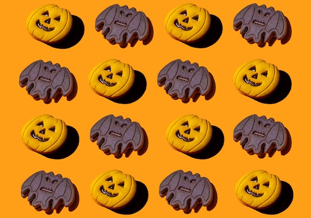 Motif de jolis biscuits aux formes de citrouille et de chauves-souris. Arrière-plans pour Halloween