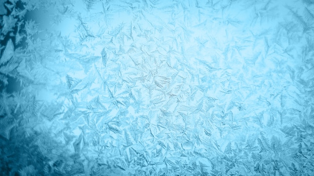 Photo motif de noël givré à une vitre d'hiver