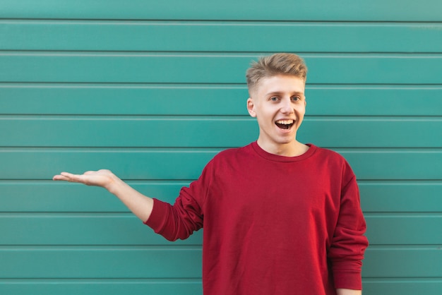 Émotionnel jeune homme heureux montre un coup de main