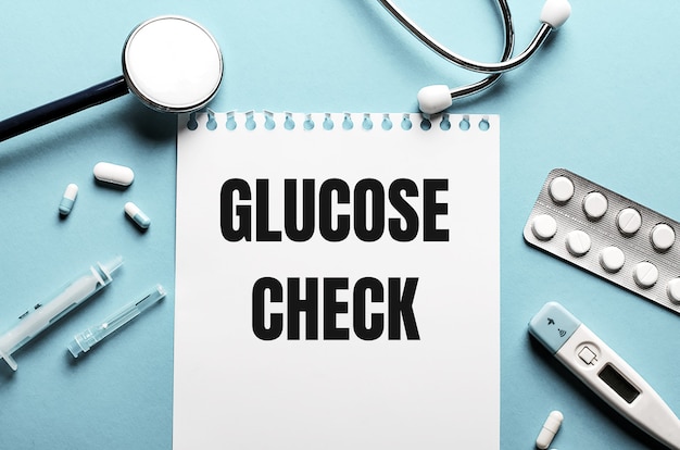 Les mots GLUCOSE CHECK écrit sur un bloc-notes blanc