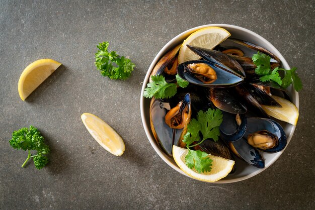 moules fraîches aux herbes dans un bol au citron