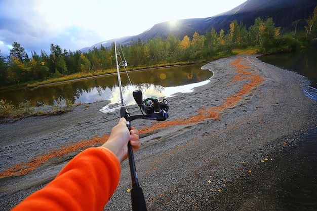 Moulinet dans la nature de pêche à la main, fond abstrait, homme de vacances passe-temps